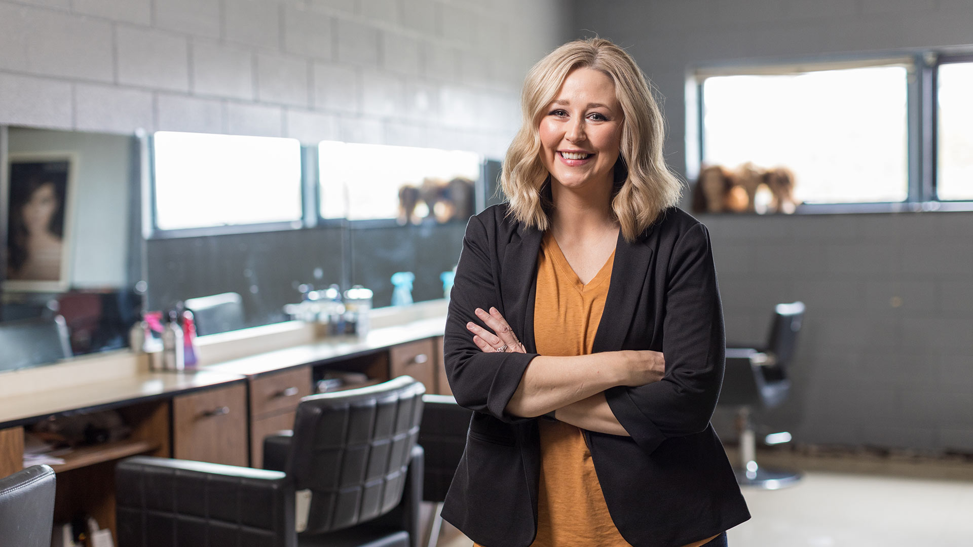 Woman standing in an office looking at camera smiling